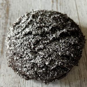 Chocolate cookie with powdered sugar on top.