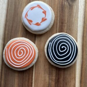Three decorated cookies with spiral designs.