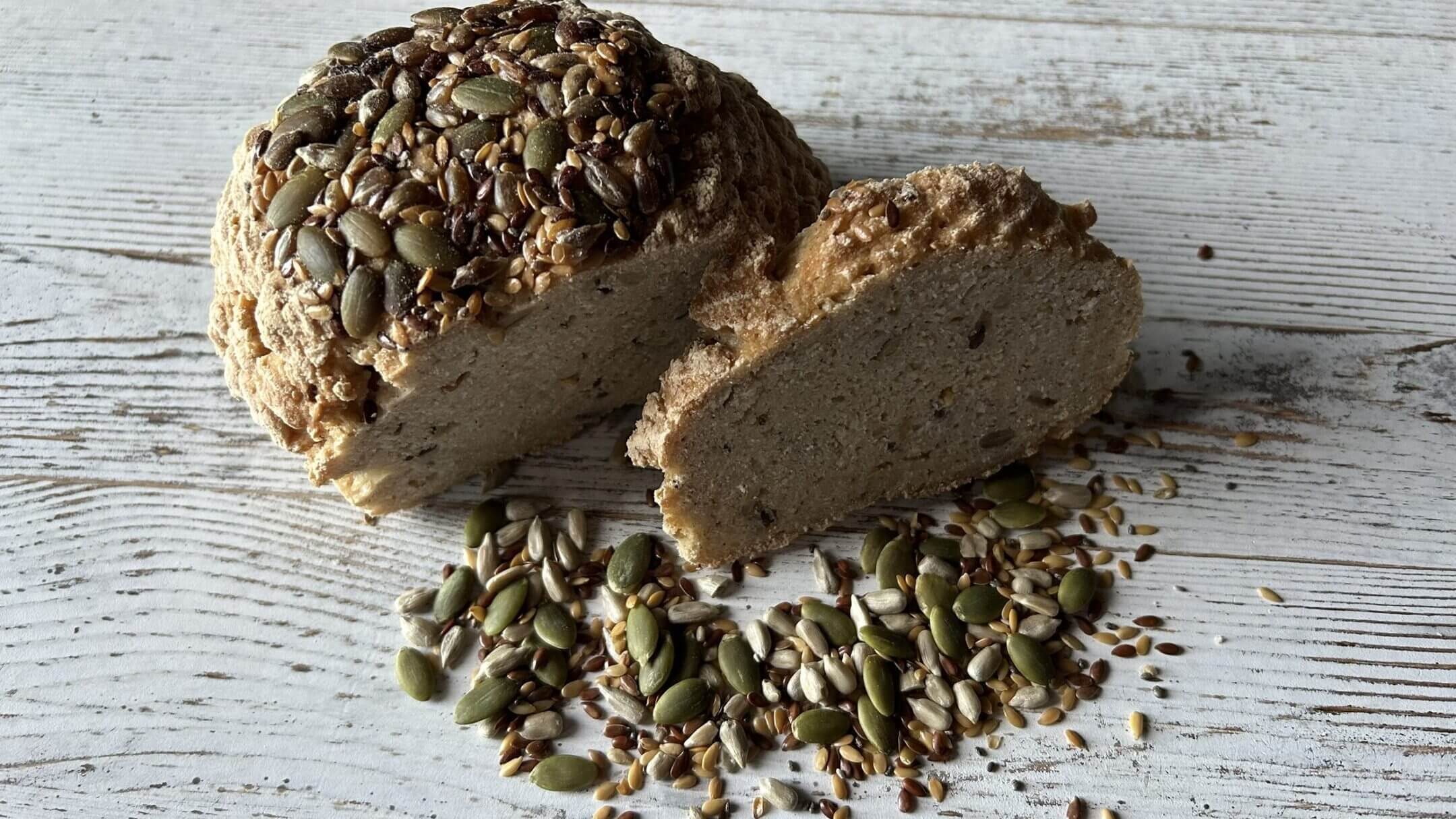 Whole grain bread with seeds on table.