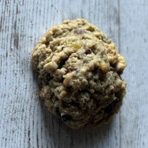 Cookie on a textured wooden surface.