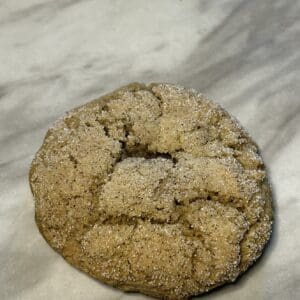 Cracked cookie on a marble surface.