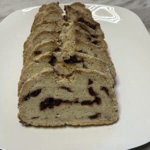 Sliced bread with raisins on white plate.